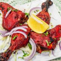Tandoori Chicken Half · Spring chicken marinated overnight in yogurt flavored with fresh aromatic Indian spices and ...