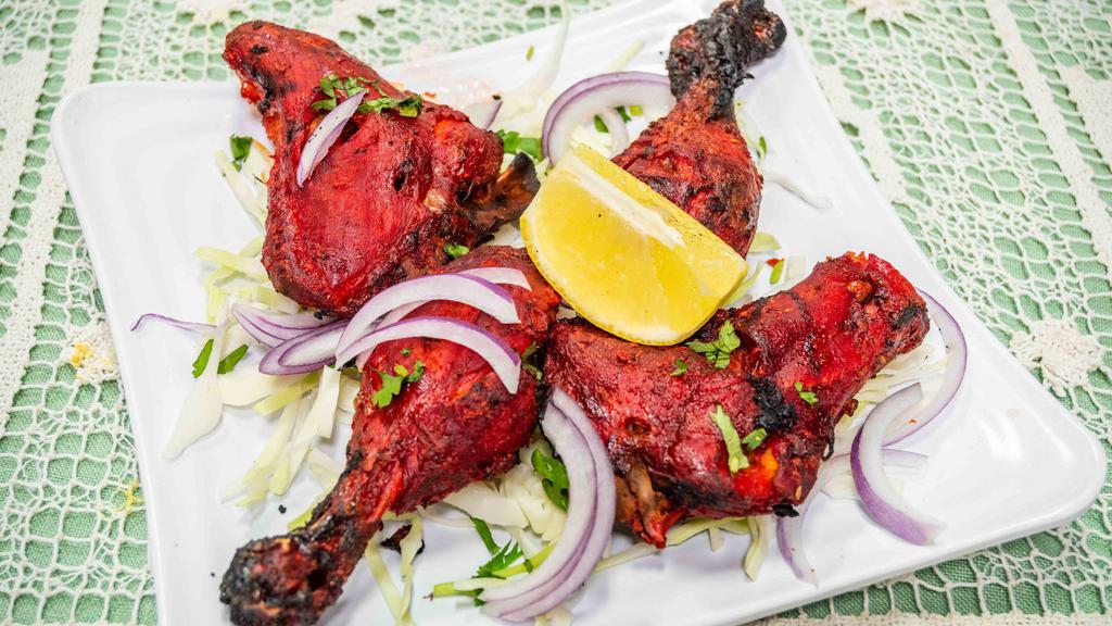 Tandoori Chicken Half · Spring chicken marinated overnight in yogurt flavored with fresh aromatic Indian spices and herbs, cooked in the Indian clay oven.