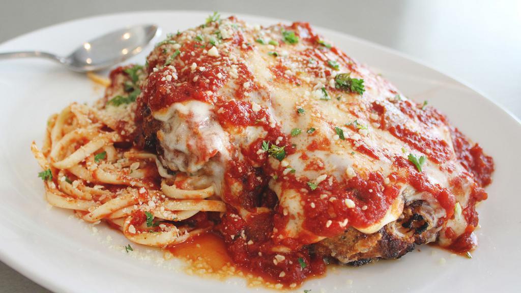 Chicken Parmesan · Pan fried cutlet topped with fresh mozzarella cheese over linguini with housemade marinara.