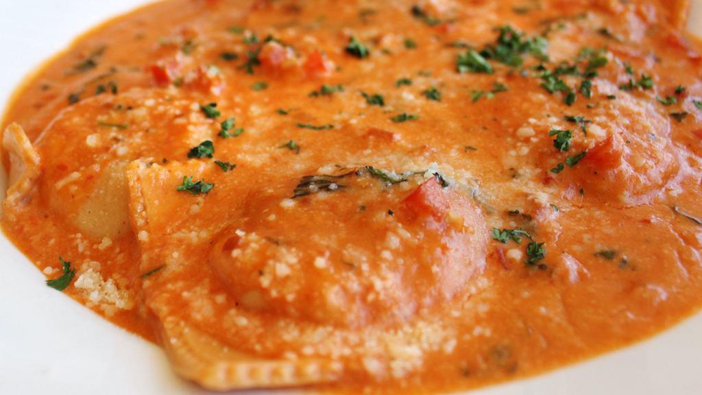 Lobster Ravioli · Mushrooms, peas, garlic, Parmesan cheese, diced tomatoes, white wine, herb, cream sauce
