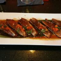 Pepper Tuna Tataki · 7pcs pepper tuna, scallion masago, radish sprouts, ponzu sauce.