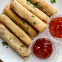 Lumpiang Shanghai · Beef, onions, celery, carrots stuffed egg roll with a side of sweet chili sauce and banana k...