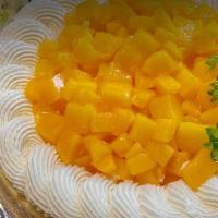 Mango Cheesecake · Tropical mango flavored cheesecake with whipped cream.