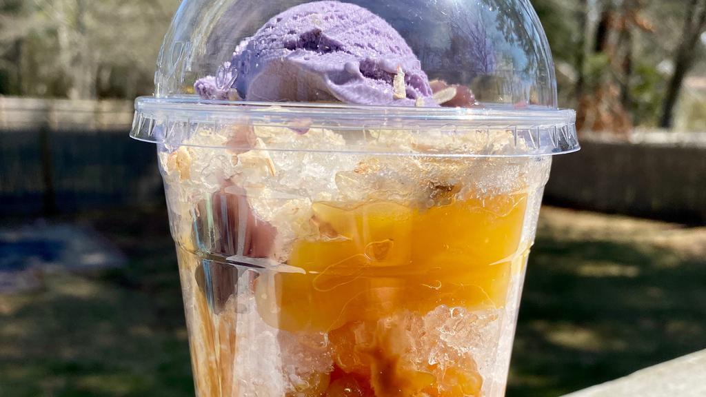 Halo-Halo · 24 oz cup Shaved Ice, crema, strawberry and pandan Coconut Gel (Nata de Coco), Chick Peas in light syrup, Palm Nut, Sweetened Jack Fruit, Toasted Sweet Rice (Pinipig), Black Beans, Sweet Corn,  Dulce de Leche, Ube Jam, topped with Ube con Queso ice cream.