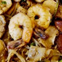 Stir Fried Flat Rice Noodle · Shrimp, chicken, fish ball, fish cake, pork sausage, and vegetables.