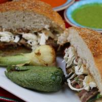 Cemita Poblana · Round sandwich with lettuce beans, cilantro, cooked onion, tomato, chipotle sauce, Oaxaca ch...
