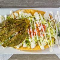 Huarache · Handmade oval tortilla topped with beans ( your choice of meat) lettuce, tomato, onion,cilan...