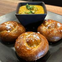 Pretzel Knots & Lager Infused Queso · Pretzel knots topped with sea salt and lager infused queso. * contains gluten and nuts *