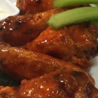 Wings · 1.5 lb of crispy fried wings tossed in choice of sauce with blue cheese and celery.