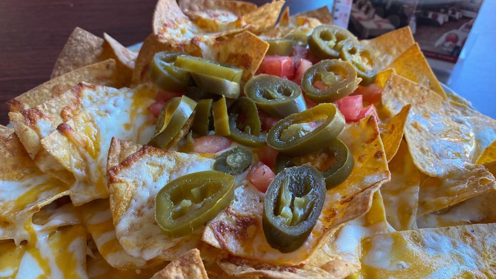 Dockside Double Cheese Nachos · Mixed cheeses, jalapeños and tomatoes.