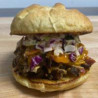 Pulled Pork Sandwich With One Side · Meticulously hand-pulled smoked pork, piled high on a toasted roll, topped with tangy slaw a...