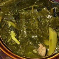 Collard Greens · Collard greens, cooked in a smoked pork stock with sauteed onions and butter.