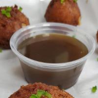 Hushpuppies · fresh made hushpuppies with, corn, jalapeno, and cheddar jack cheese.  Served with a maple b...