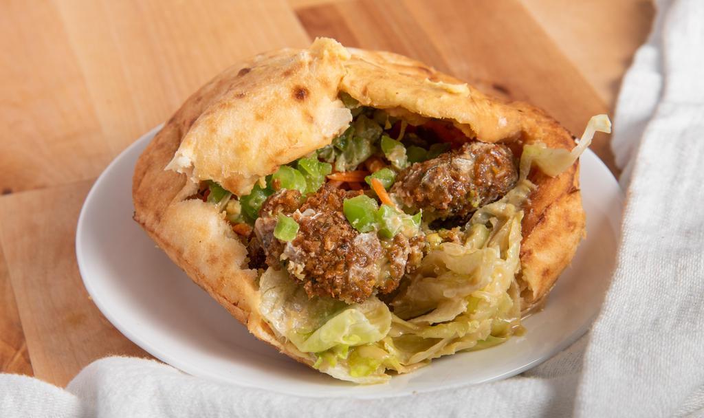 Falafel · ground garbanzo beans with parsley, cilantro, onions, garlic and seasonings served in a pita pocket with hummus, green salad and tahini sauce.