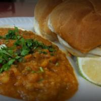 Usal Pav · dried green peas and white peas curry served with buttered bread and garnished with onions, ...