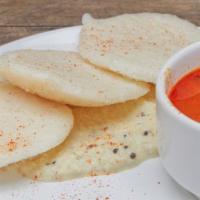 Idli · steamed rice and lentil cake served with coconut chutney and lentil soup.