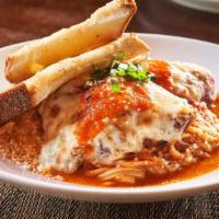 Chicken Parmesan · Crispy fried breast of chicken over fresh linguine, homemade marinara, chopped basil, Parmes...