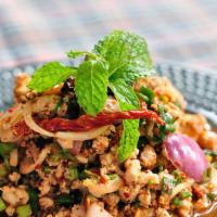 Larb Kai · Spicy. Minced chicken with red onion, scallion in spicy lime juice and dried chili.