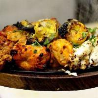 Mix Tandoori Sizzler · Combination of seasoned tandoori chicken, sheekh kabab, tandoori shrimp, chicken tikka and f...
