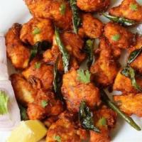 Chicken 65 · Slightly battered fried chicken marinated in yogurt, spices and stir fried with onions and c...