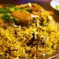 Chicken Dum Biryani · Long grain basmati rice delicately cooked on dum with chicken, yogurt, and special spices.