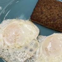 Two Eggs With Scrapple  · Served with potatoes, toast and jelly.