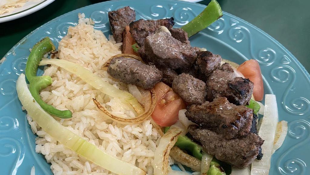 Shish Kabab · Marinated slices of beef mixed with green peppers, onions, and tomatoes charbroiled. Served over rice with hummus and hot grilled pita bread.