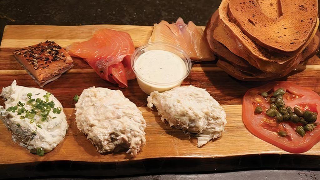 Ivy City Smokehouse Fish Board · pepper salmon, salmon candy, smoked rainbow trout, great lakes white fish salad, smoked salmon spread, tomato, red onion, chive cream cheese, bagel chips