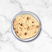 Wheat Flat Bread · An unleavened whole wheat flatbread baked to perfection in a clay oven. A perfect accompanim...