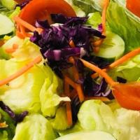 Garden Salad · Lots and lots of lettuce, tomato, and other fresh in-season veggies and dressing.