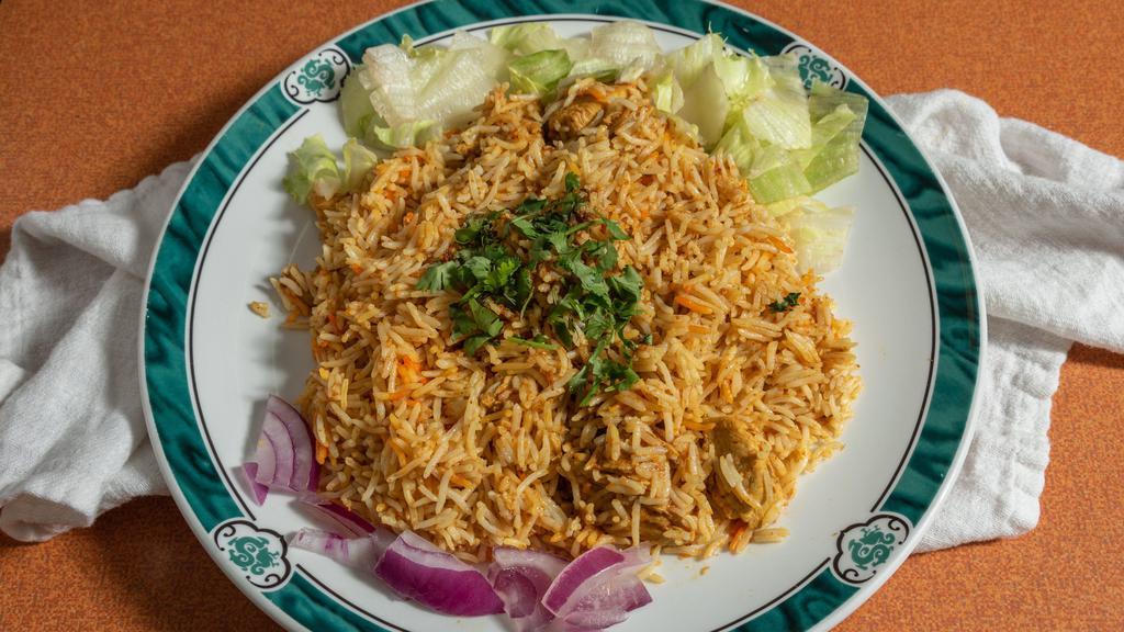 Chicken Biryani · Pieces of chicken and long grain basmati rice cooked in a sealed pot.