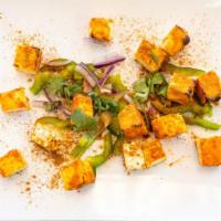 Tandoori Paneer · Homemade cottage cheese mildly marinated in herbs and spices. Served with bell peppers, toma...