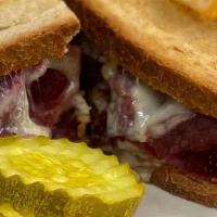 Grilled Reuben · Corned beef with Russian dressing, swiss cheese & sauerkraut on grilled rye with fries