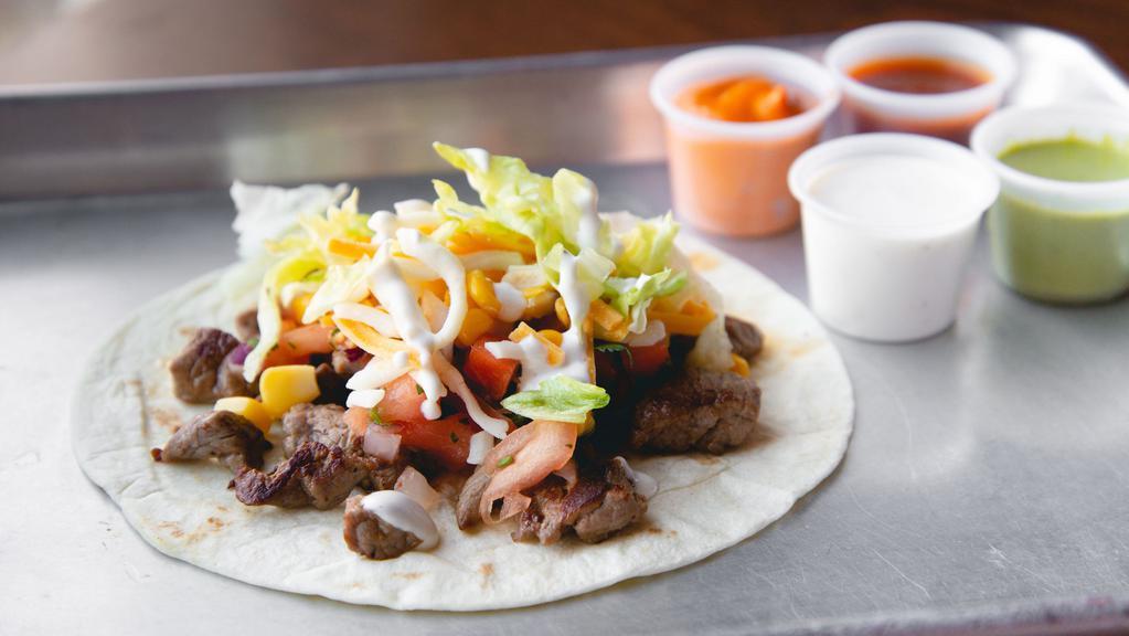 Taco · Corn or flour tortilla, with your choice of protein and toppings.