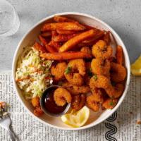 Popcorn Shrimp Basket · Popcorn shrimp served with cajun fries, cole slaw and house bbq sauce.