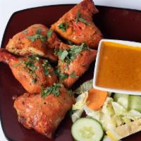 Tandoori Chicken · Chicken (leg and breast) marinated in herbs and spices and cooked in tandoor.