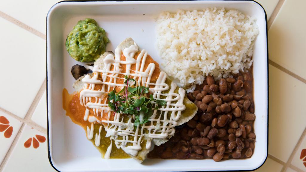 Vegan Enchiladas · House rolled heirloom tortillas stuffed with choice of filling (organic cremini mushrooms sauteéd in garlic & tequila & black refried beans OR local Vertage vegan Oaxacan cheese w/cashew base) and served with rice, pinto beans, guacamole and topped with cashew cream & choice of salsa (GF/vegan/soy free)