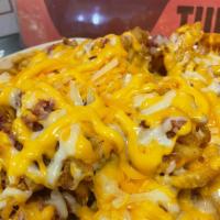 Rancho Waffle Fries · Topped with bacon bites, Cheddar Cheese & Ranch dressing on a side.