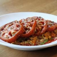 Moroccan Tomatoes Tagine · House-roasted tomatoes, basil olive oil drizzle, over berbere quinoa, leeks, fennel, buttern...