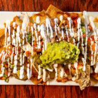 Nachitos · Gluten free nachos, topped with chihuahua cheese, garnished with pico de gallo, sour cream, ...