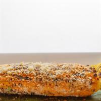 Elote Asado · Corn on the cobb, smothered with chipotle mayo, cotija cheese, and touch of lime juice.