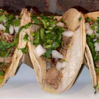 Carnitas Taquito · Slowly marinated braised pork, topped with cilantro, and onions.