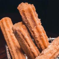 Churros · Fried dough covered with cinnamon & sugar. Served with Mexican hot chocolate.
