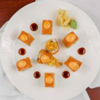 M -16 Roll · Shrimp tempura and asparagus inside topped with salmon and spicy sauce.