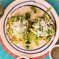 Tostadas · Open face crispy corn tortilla (thin), topped with beans, lettuce, fresh cheese and sour cre...
