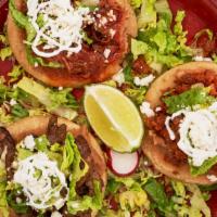 Sopes · Open face homemade com tortilla (thick), topped with beans, meat of your choice, lettuce, fr...