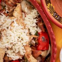 Alambre · Bell pepper and onions, mixed with meat, topped with chopped bacon and cheese. served with c...