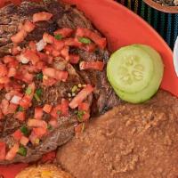 Carne Asada · Sliced grill ribeye steak, served with rice, beans, pico de gallo and three corn tortillas o...