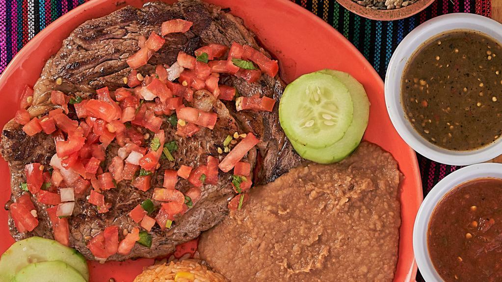 Carne Asada · Sliced grill ribeye steak, served with rice, beans, pico de gallo and three corn tortillas on the side.