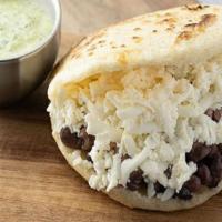 Dominó · Arepa stuffed with black beans and shredded queso fresco. Gluten-free and vegetarian.